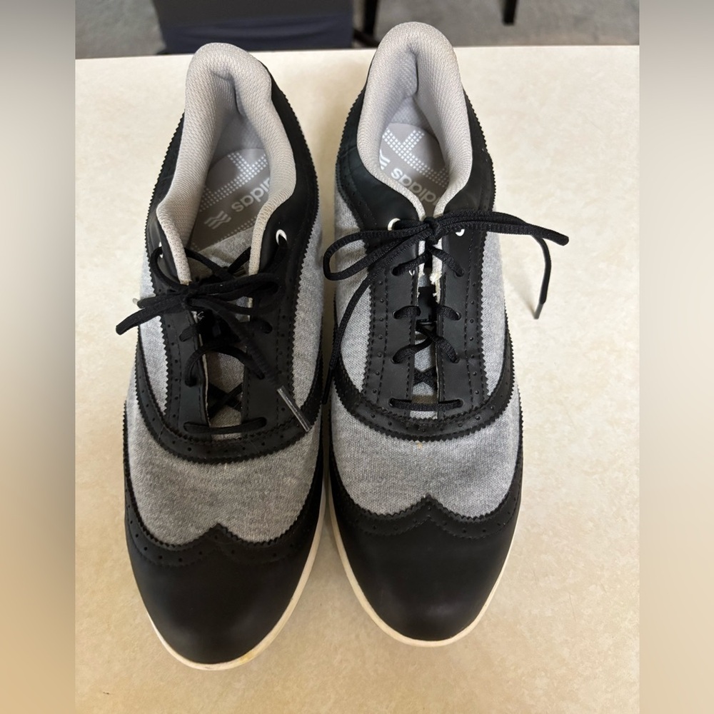 Adidas women’s Black and Gray golf shoes.